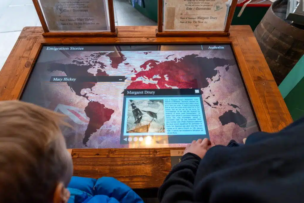 Visitors exploring an interactive emigration display at Cobh Heritage Centre