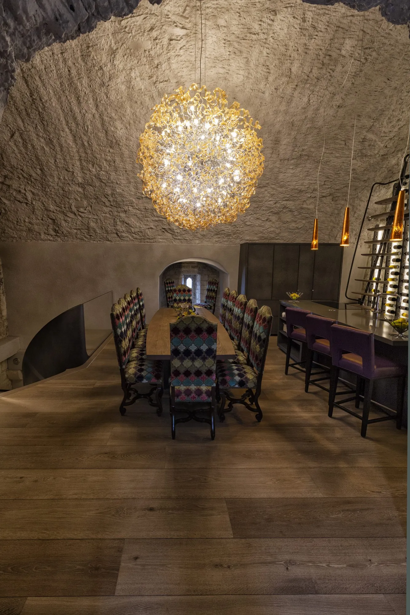 The length of the vaulted dining room with wine storage along one wall