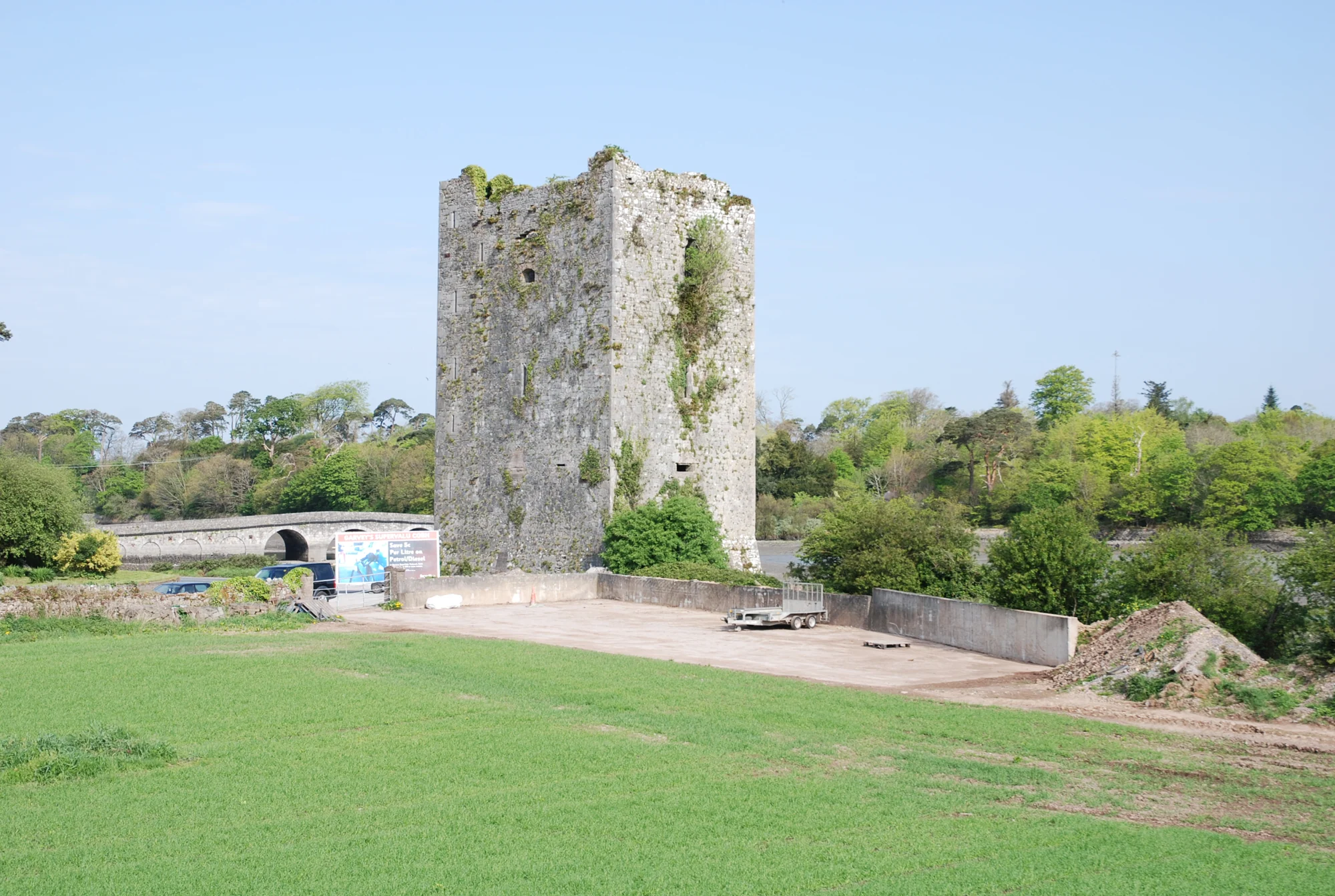 Belvelly Castle standing unroofed above open ground before its modern restoration