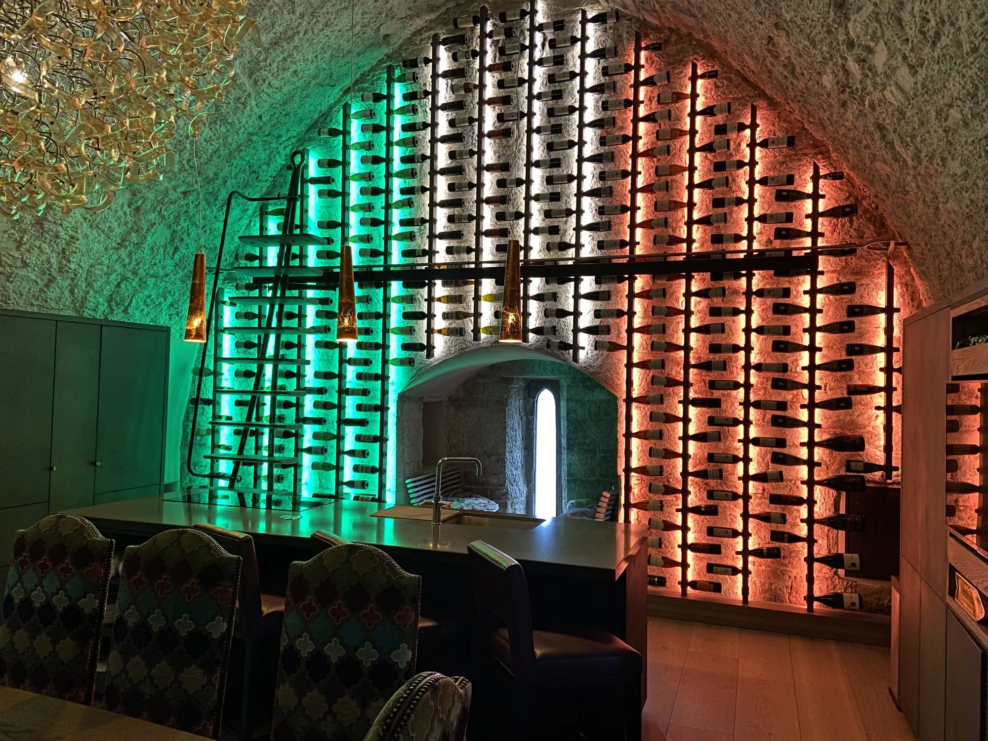 Vaulted room within the castle lit in green and orange